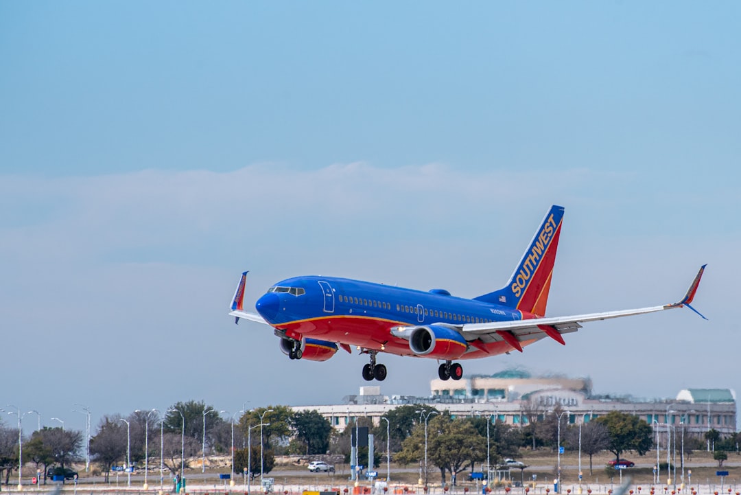 red and white airplane on airport during daytime