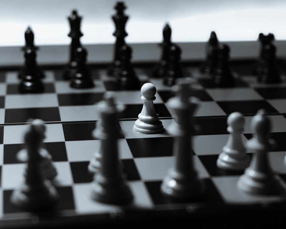 A Game Of Chess With Various Pieces And A Black And White Chess Board  Background, Game, Table Setting, Chess Background Image And Wallpaper for  Free Download