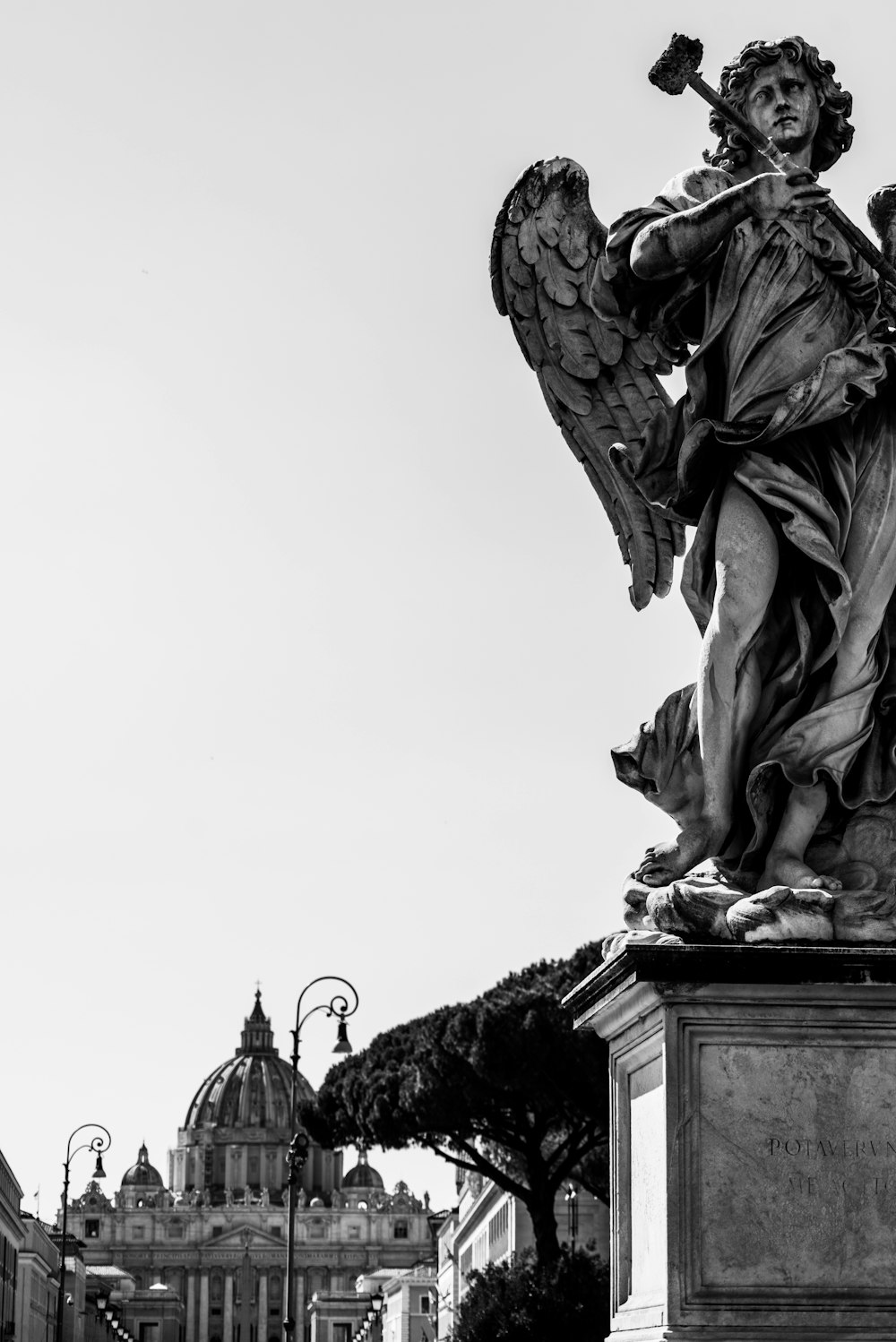 statue of man holding book