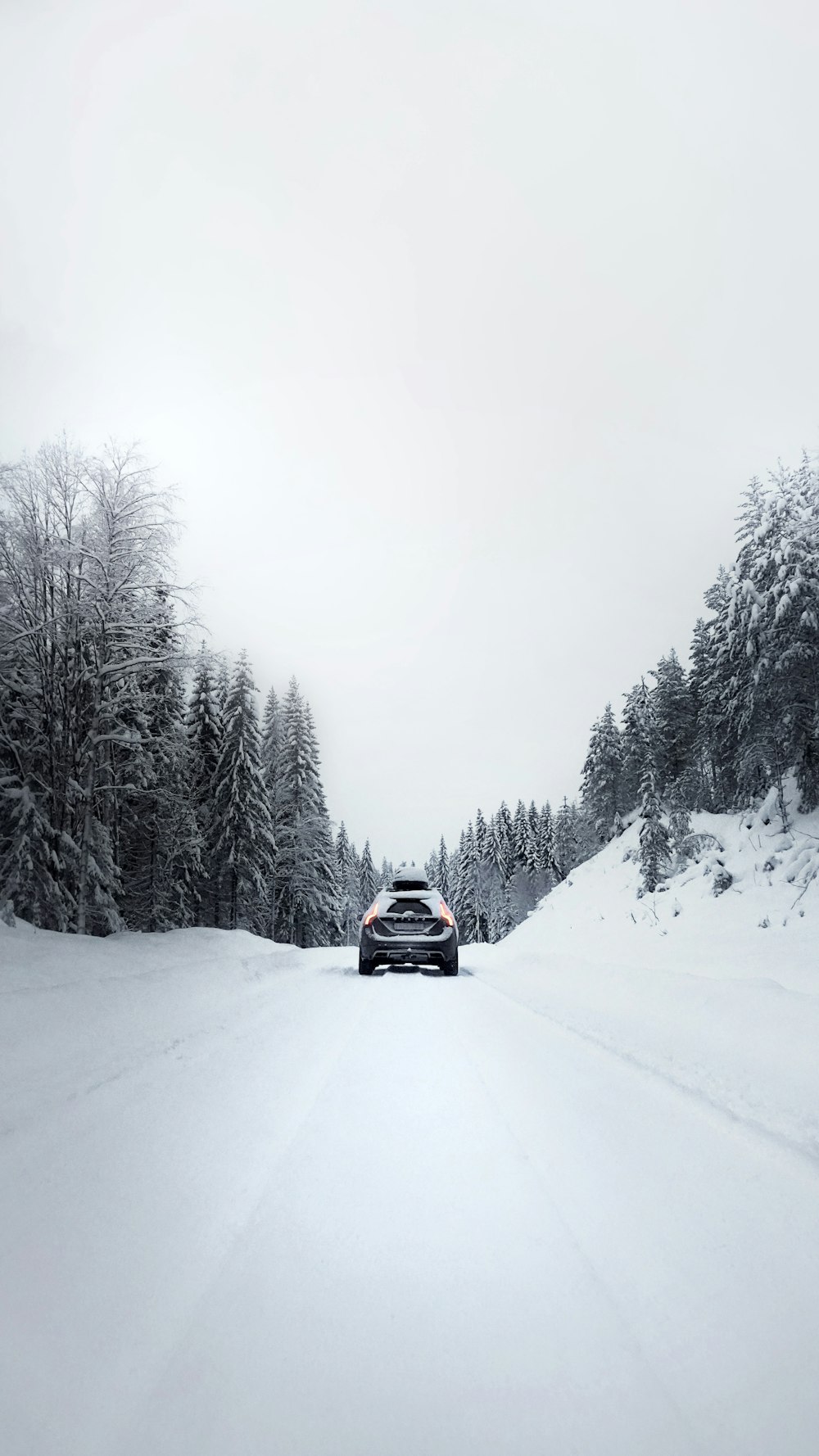 black car on snow covered road