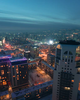 Evening view of Avida high-rise buildings with city lights.