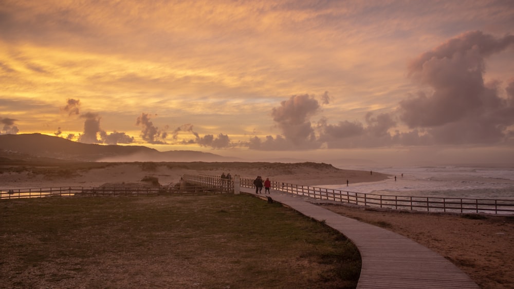 people walking on beach during sunset