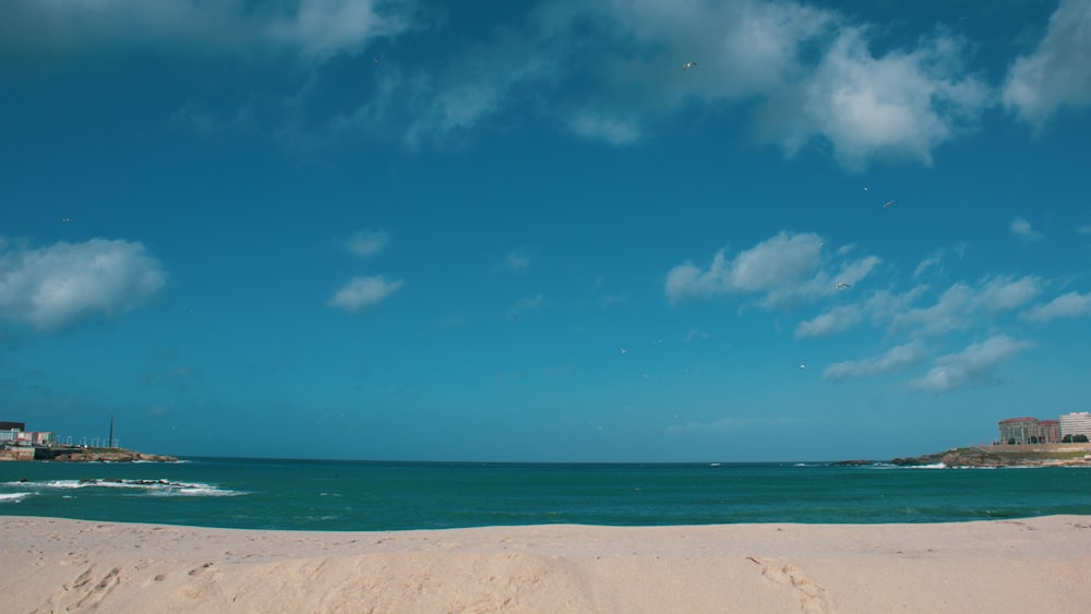 white sand beach under blue sky during daytime