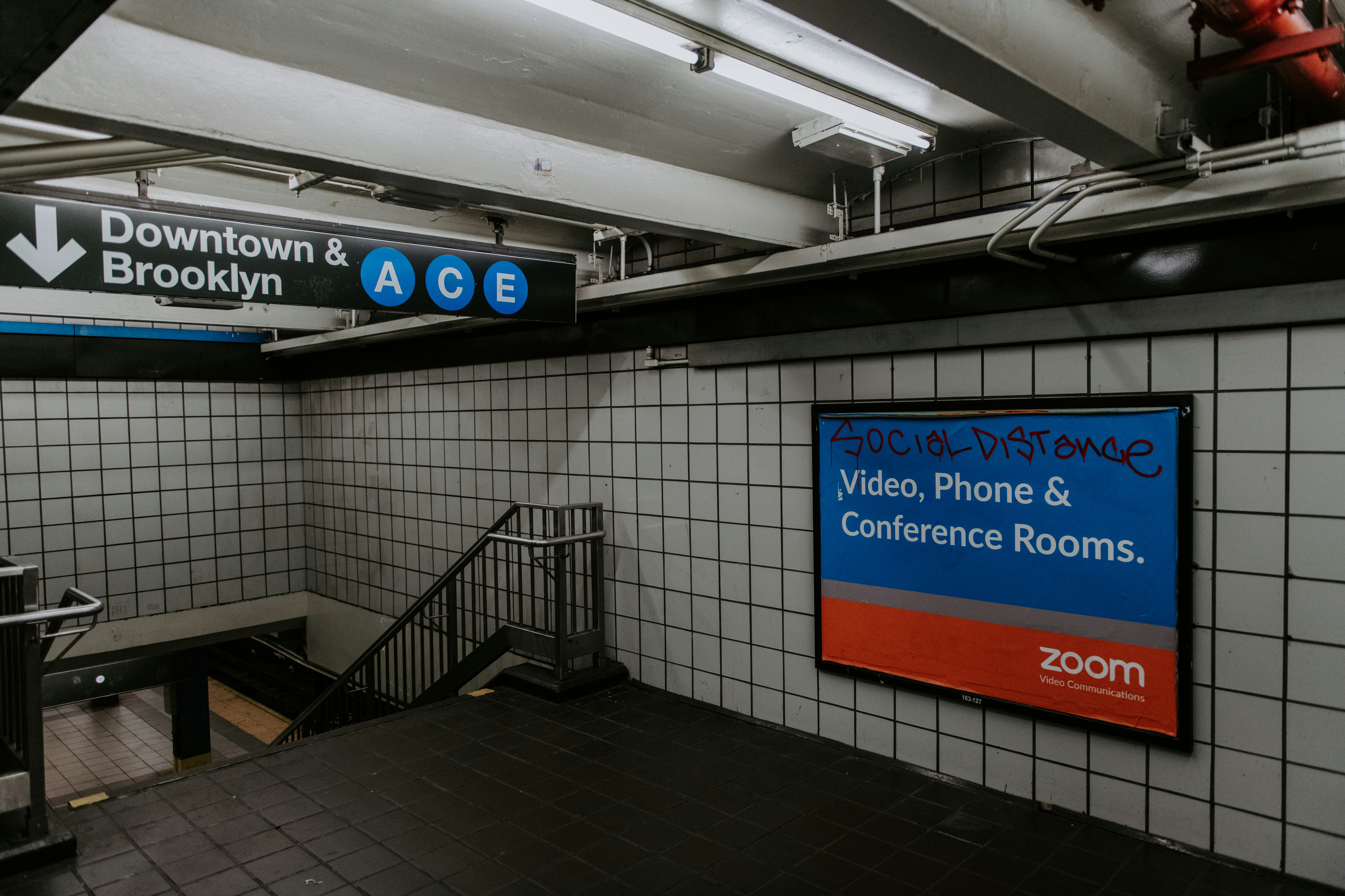 black flat screen tv turned on near staircase