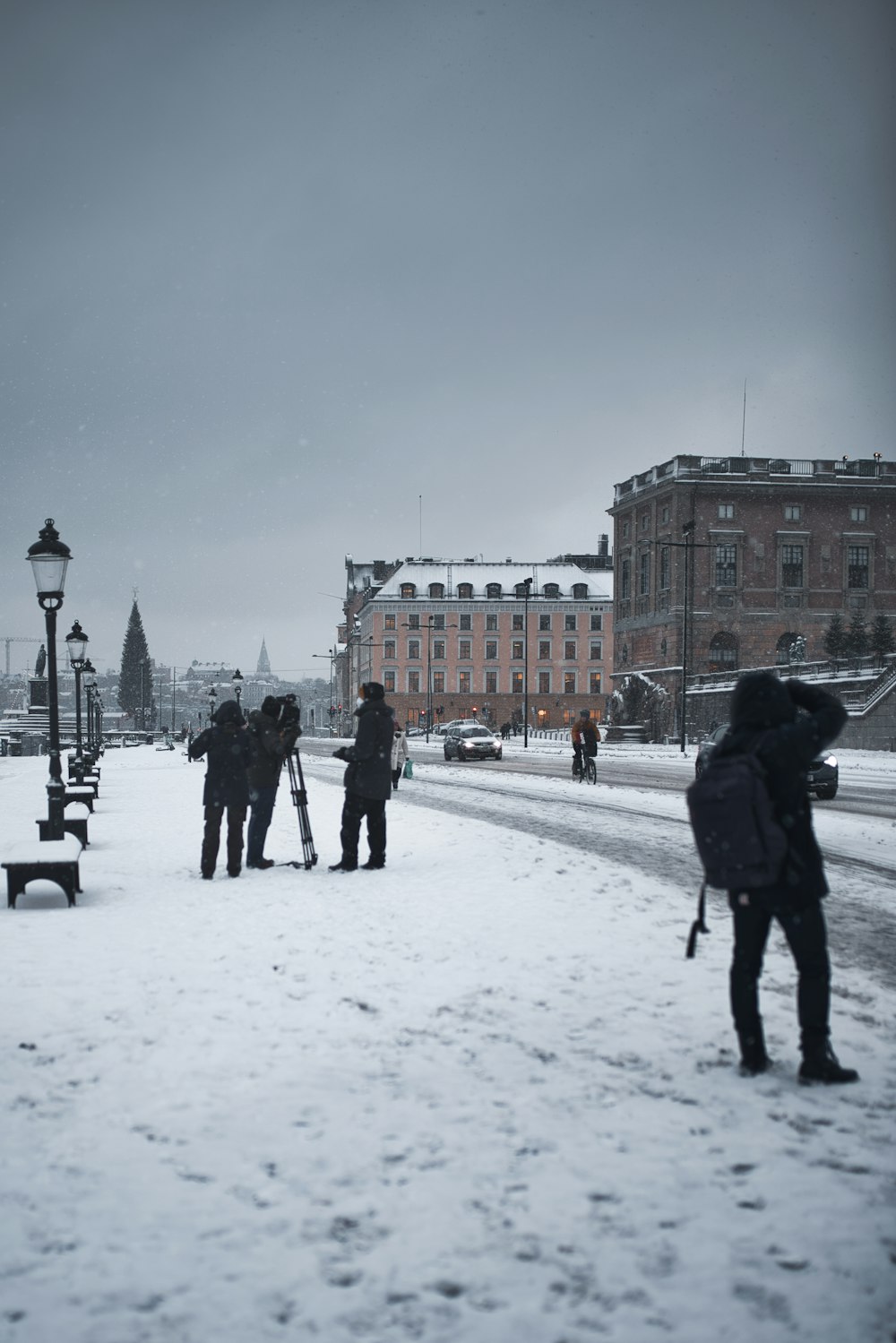 people walking on snow covered ground near building during daytime