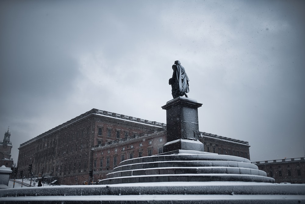 statue of man on top of building