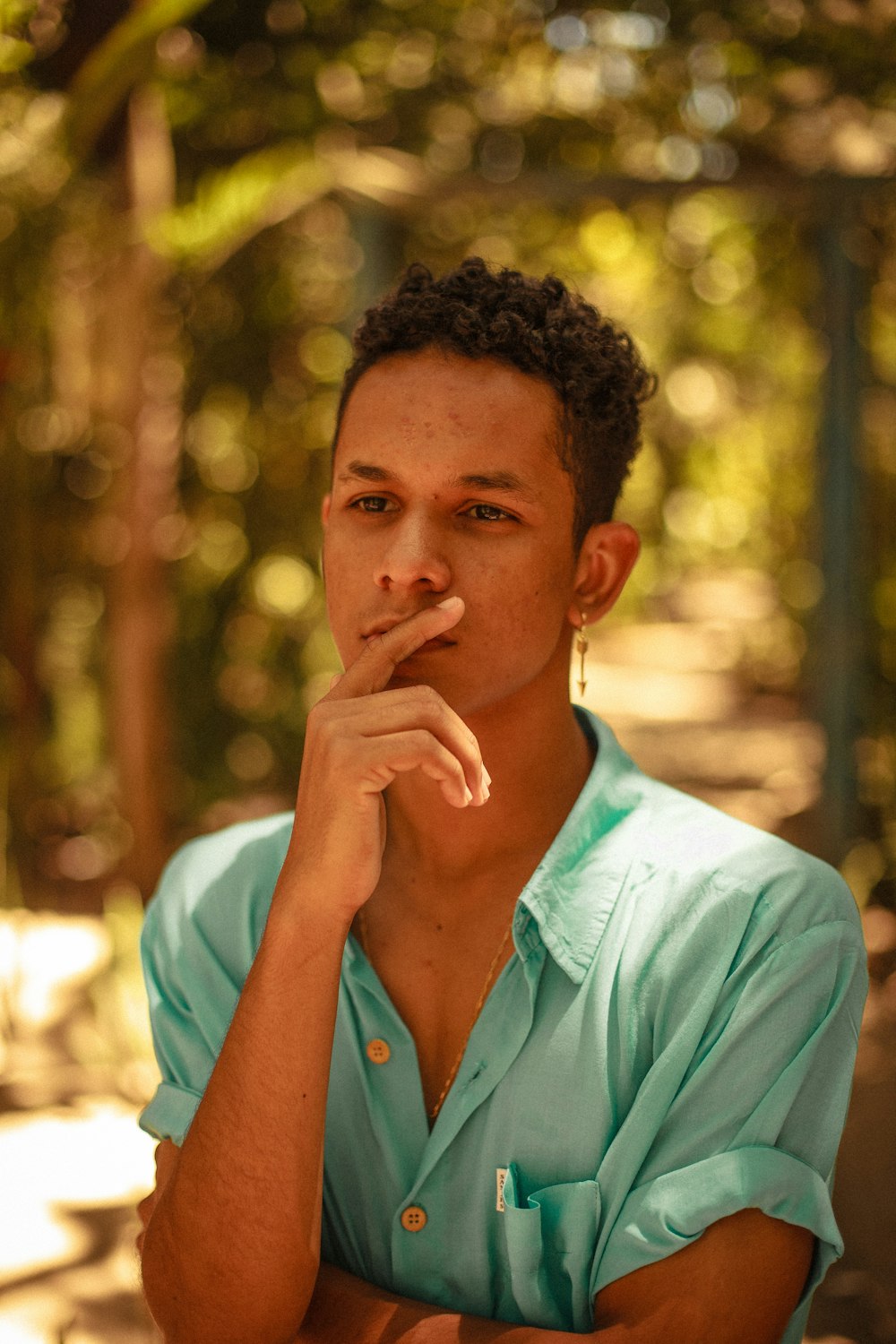 man in teal button up shirt