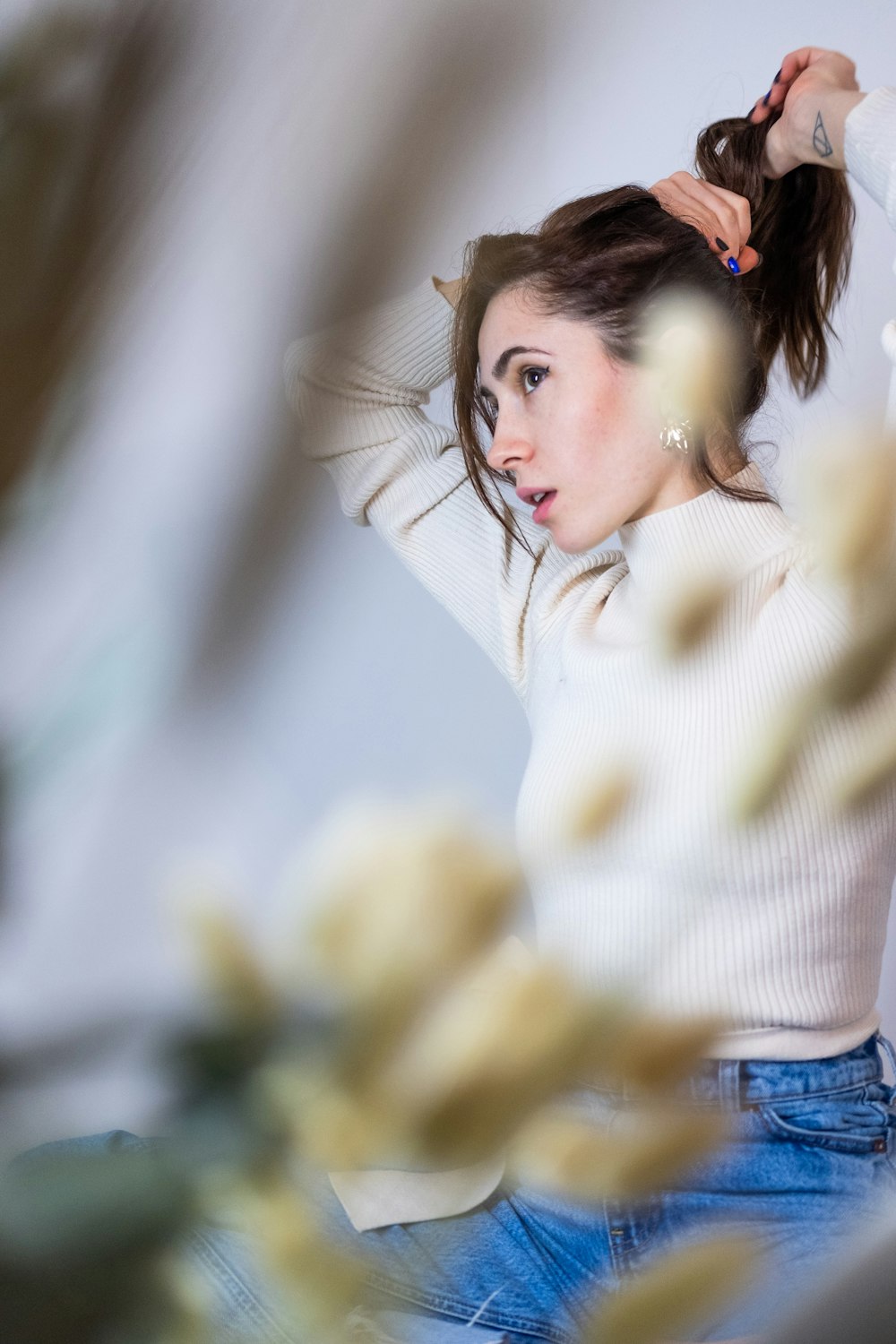 woman in white sweater and blue denim jeans