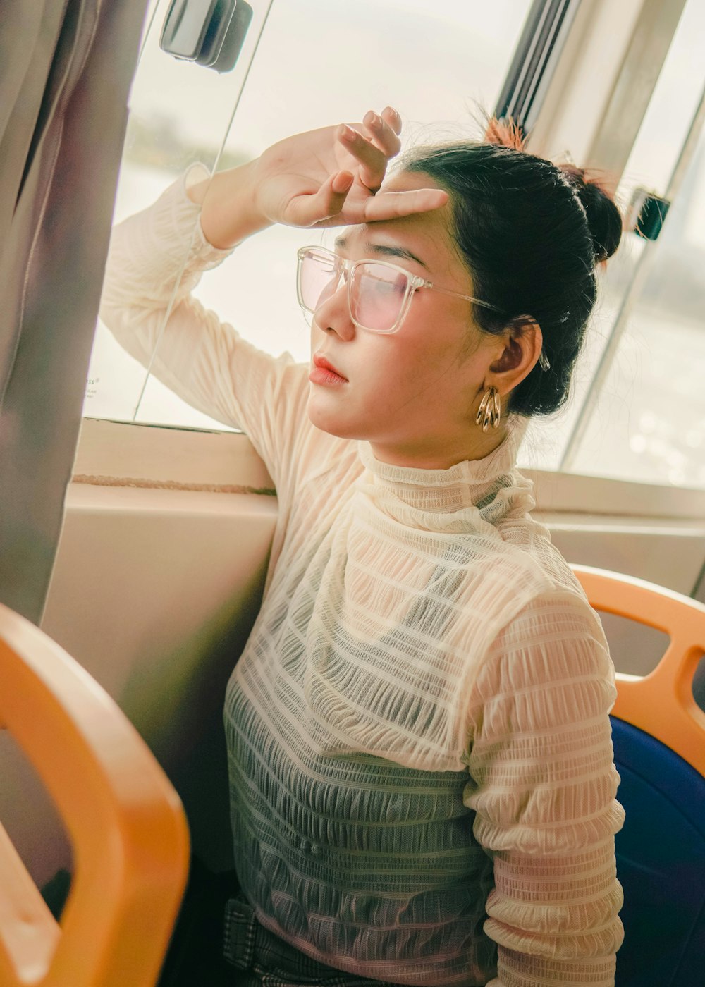 woman in white sweater wearing eyeglasses sitting on chair