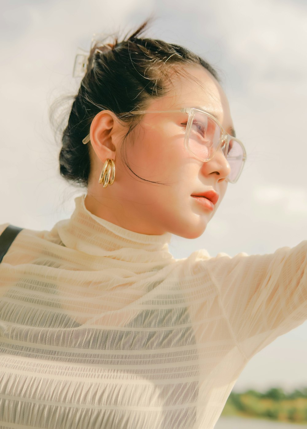 woman in white knit sweater wearing eyeglasses