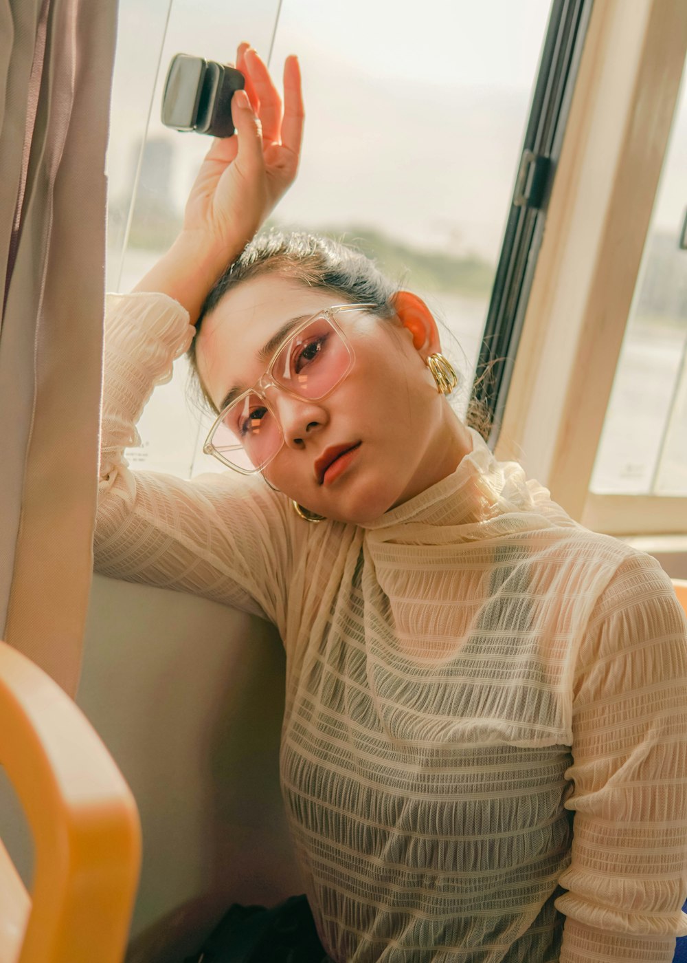 woman in white and black striped long sleeve shirt sitting on white sofa