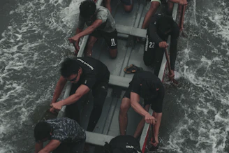 Close-up of a coach guiding athletes during an intense dragon boat training session.