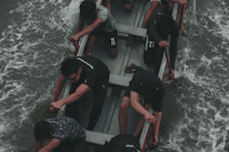 Paul coaching a rowing session at Mersey Rowing Club with focused athletes in the boat.