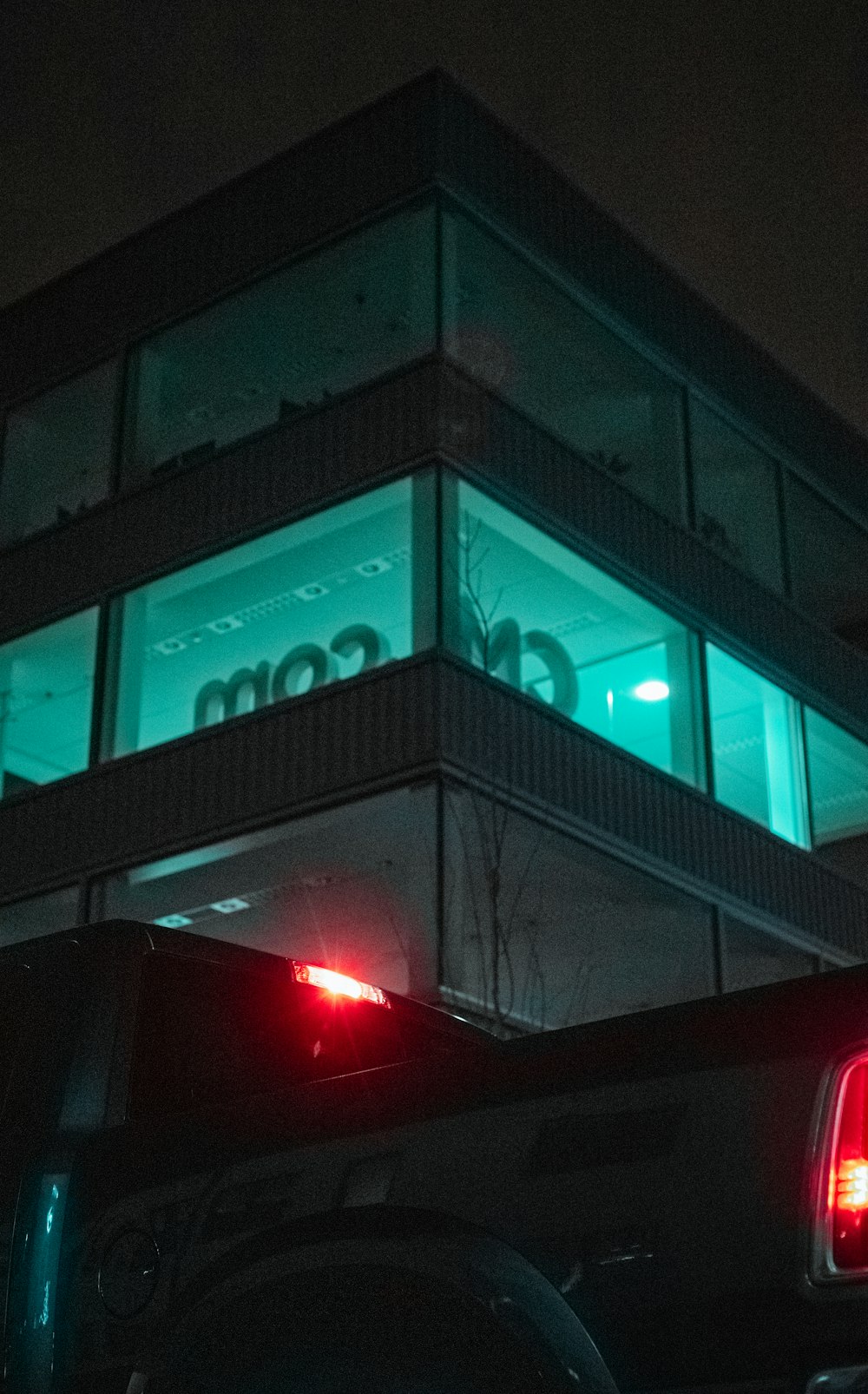 black car parked in front of building during night time