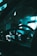 The image captures the interior of a vehicle, focusing on the steering wheel and illuminated dashboard. The dashboard displays light up with various gauges and indicators, set within a dimly lit car interior. The lighting has a cool teal tone, creating an atmospheric and futuristic look.