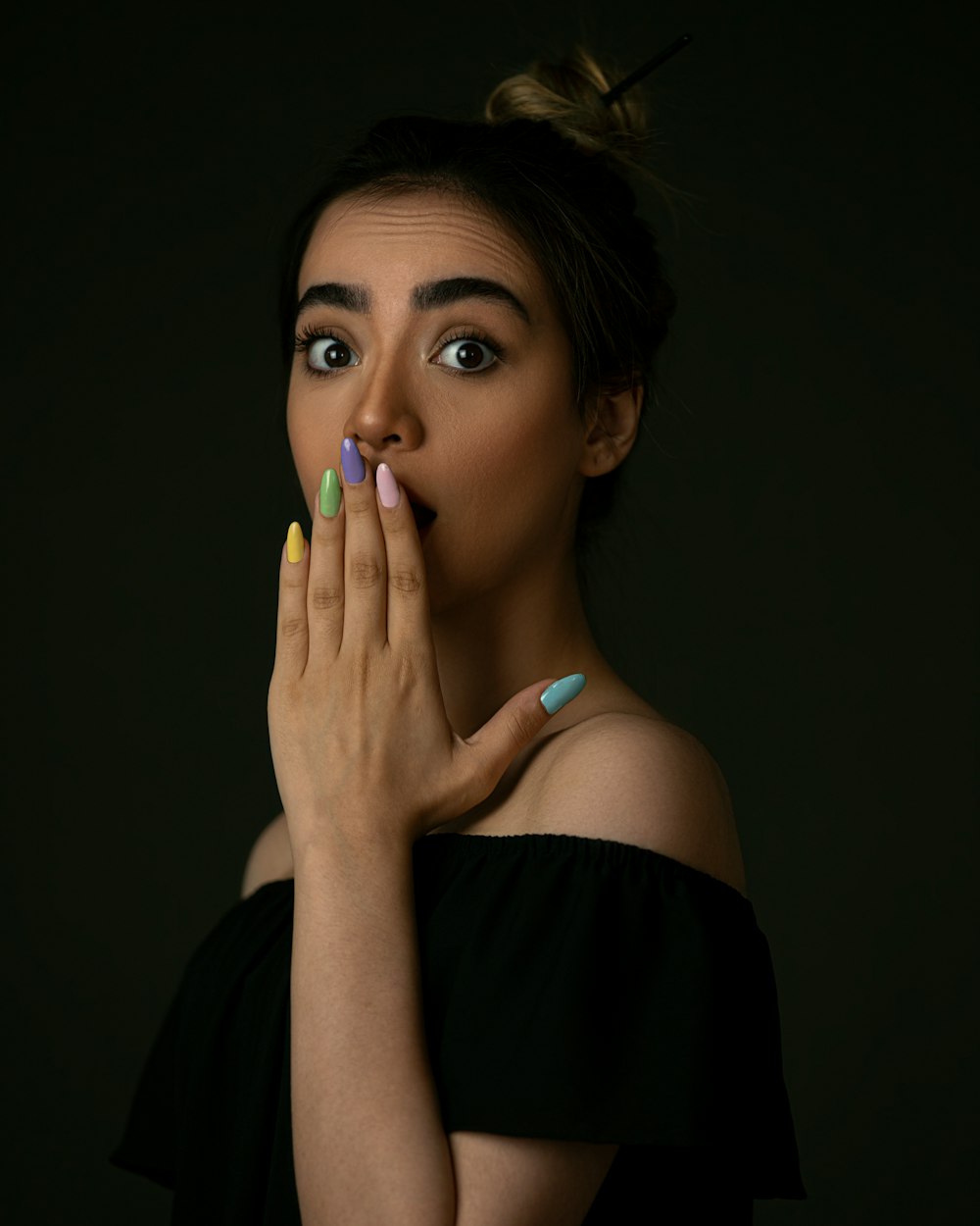 woman in black off shoulder shirt with blue manicure