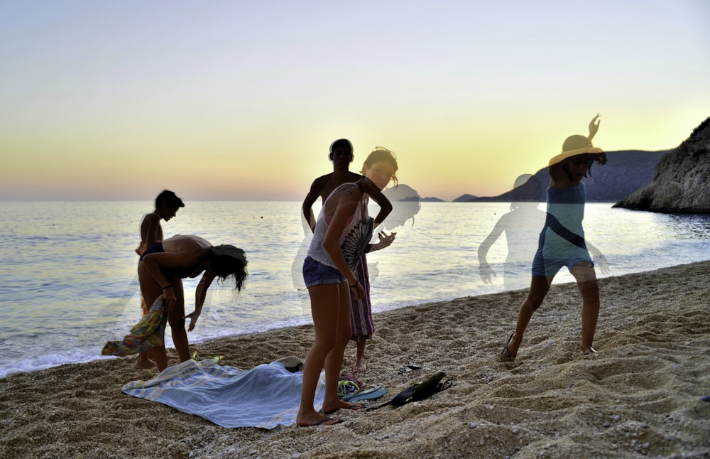 2 women in bikini walking on beach during sunset