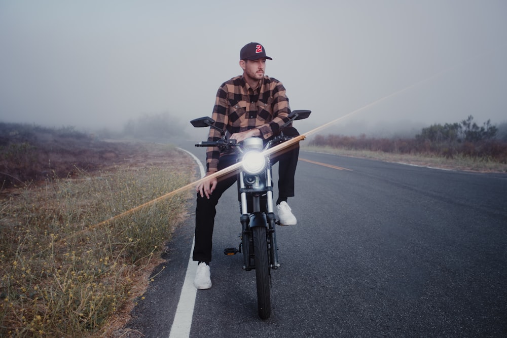 man in brown jacket riding bicycle on road during daytime