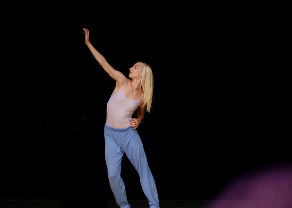 woman in white tank top and blue pants