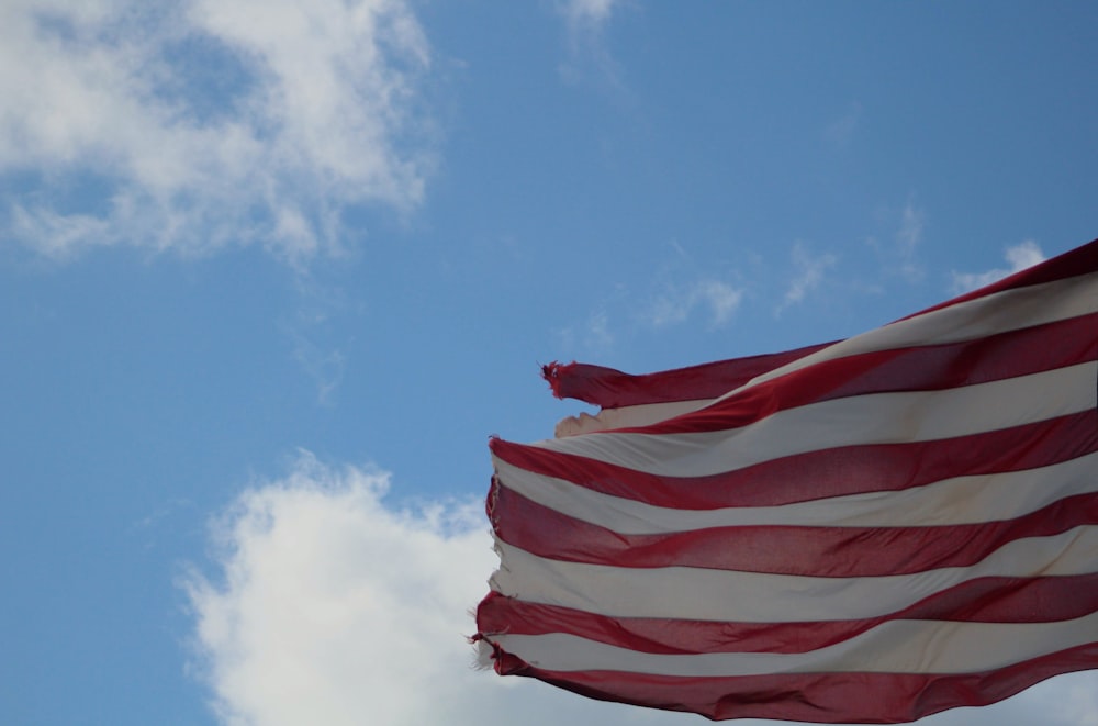 red and white flag under blue sky during daytime