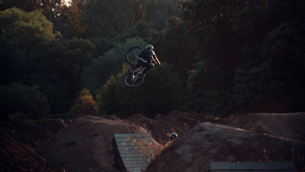 man in black jacket riding bicycle on mountain during daytime