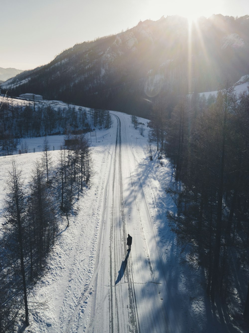 person walking on snow covered field during daytime