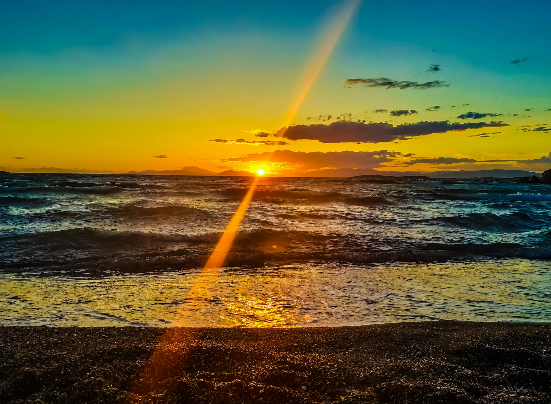 sea waves crashing on shore during sunset
