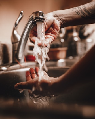 Person washing their hands in warm water in an RV