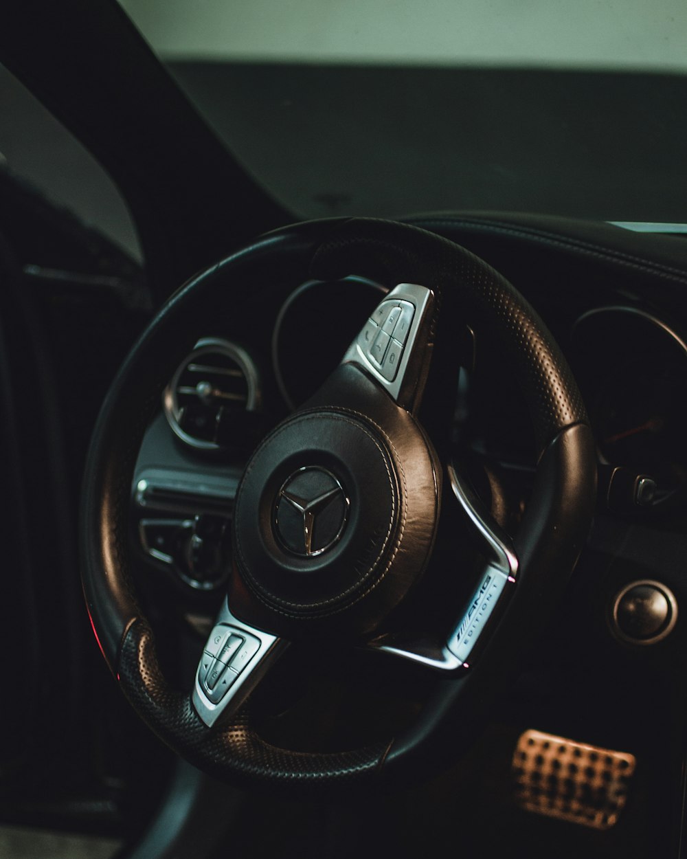 black and silver mercedes benz steering wheel