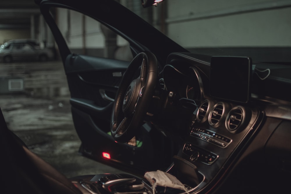 black car steering wheel and dashboard