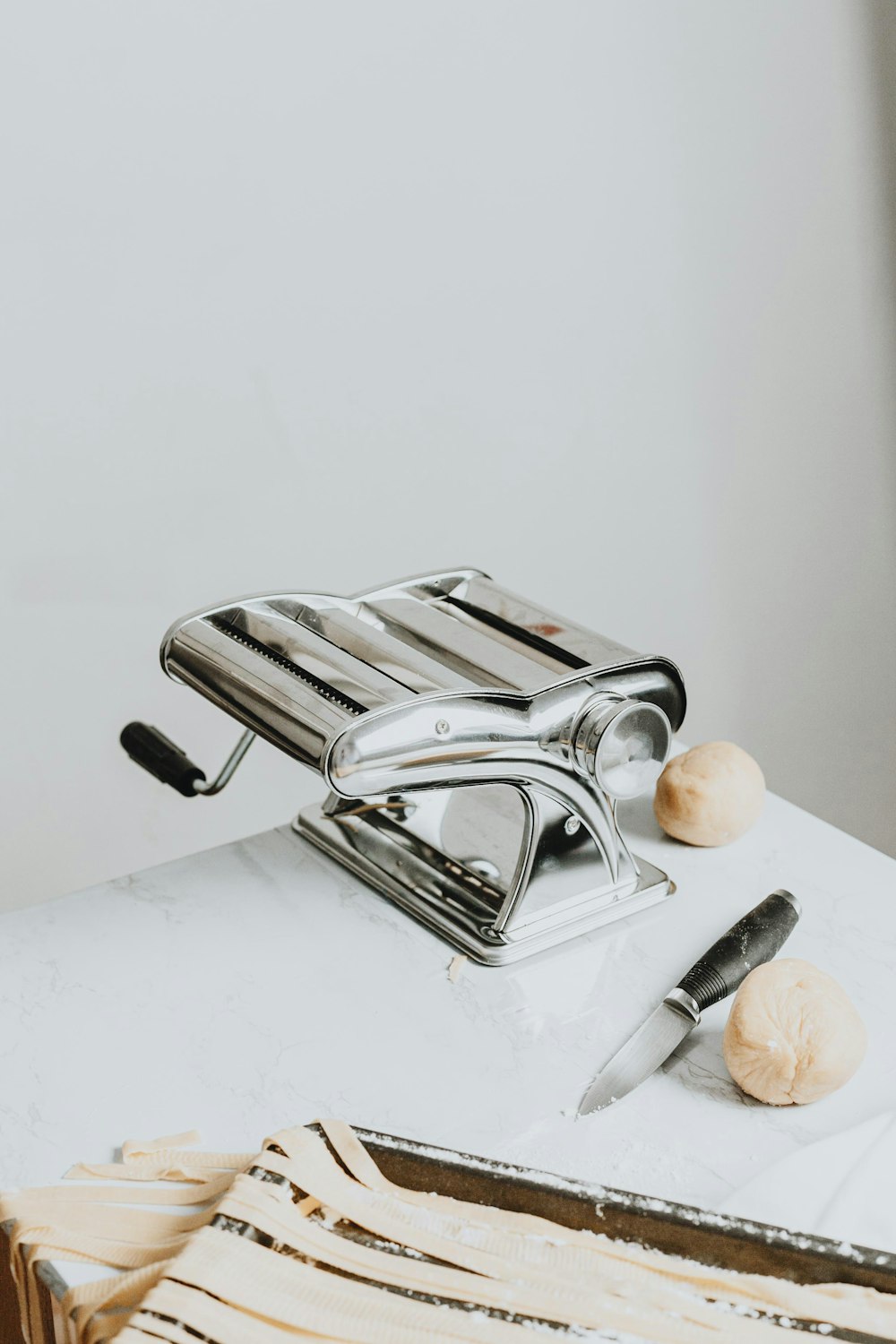 stainless steel bread toaster beside brown wooden round fruit