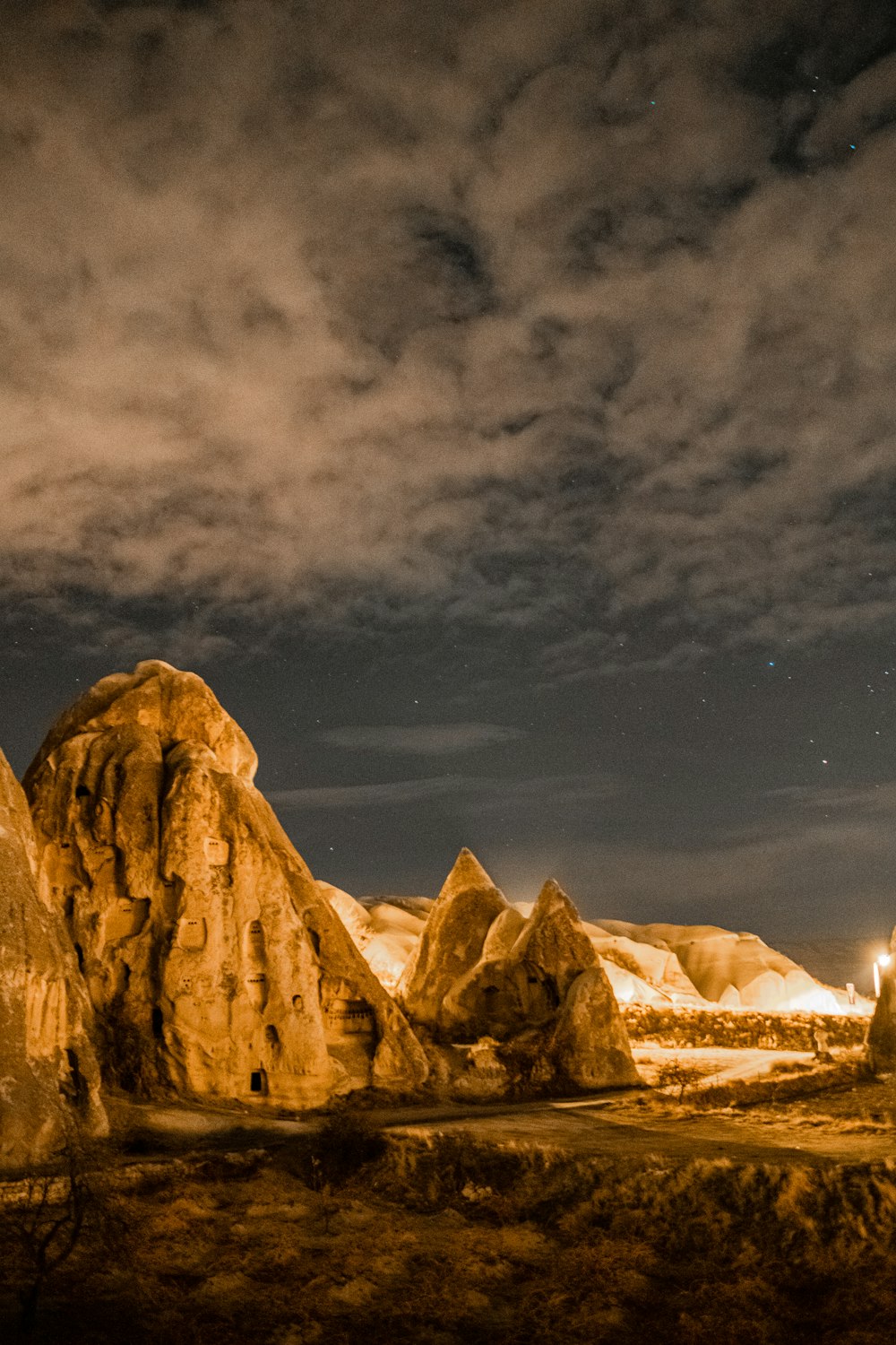 brown rocky mountain under gray sky