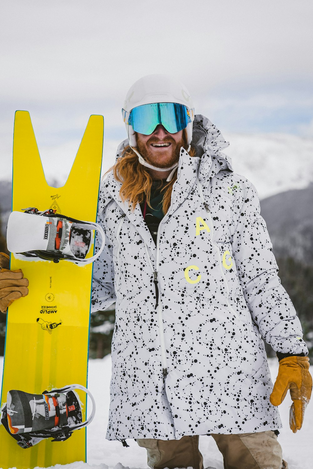 woman in white and black snow jacket wearing blue goggles