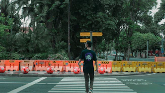 man in black jacket and black pants walking on pedestrian lane during daytime