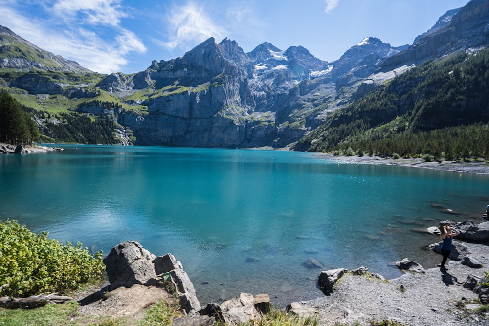 blue lake surrounded by mountains during daytime