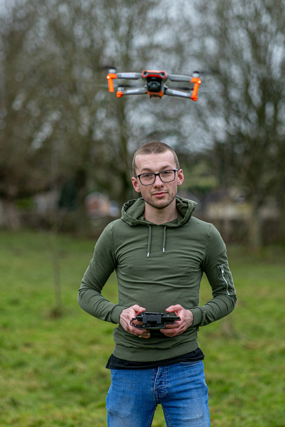 man in green zip up jacket holding black dslr camera