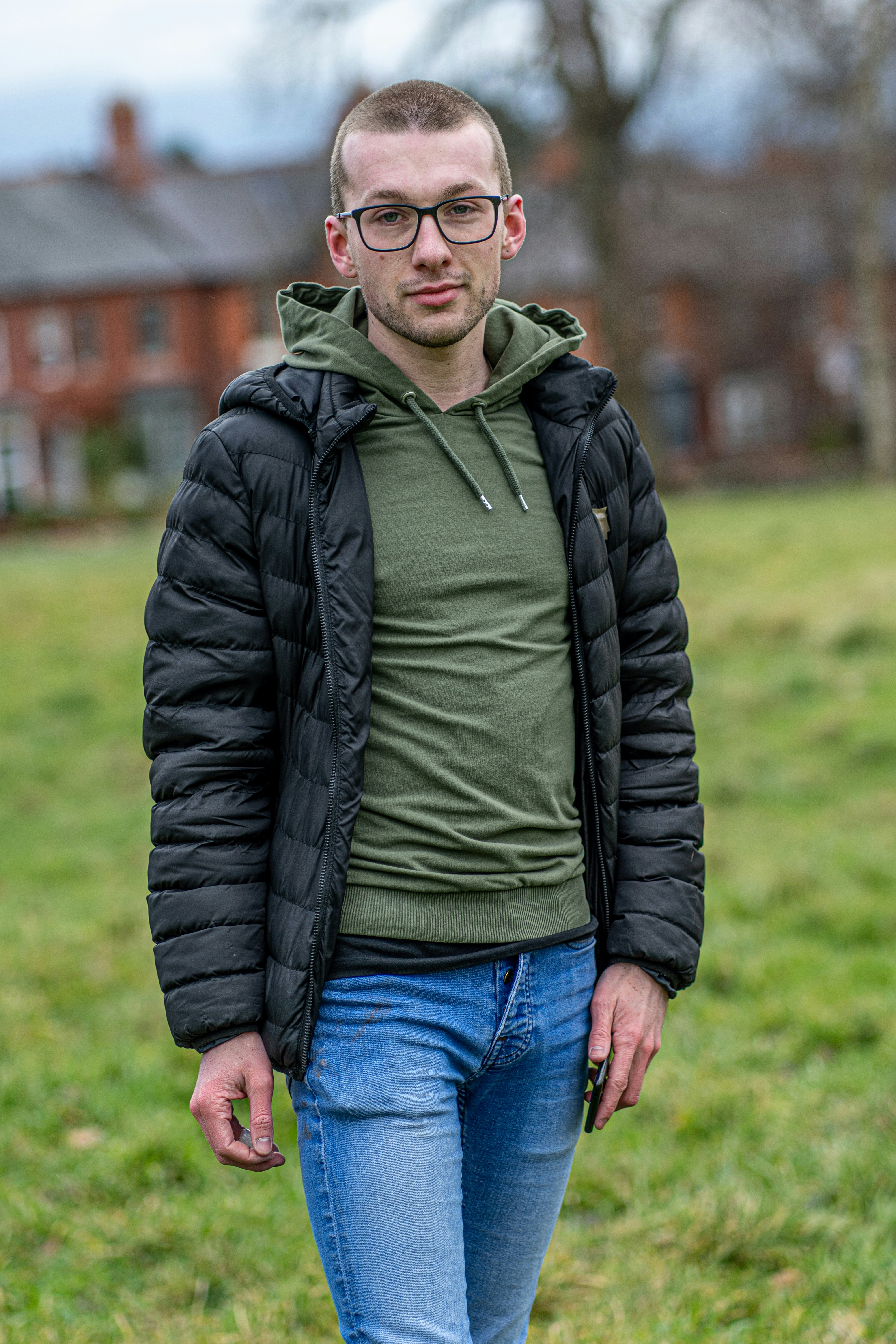 man in black zip up jacket and green shirt