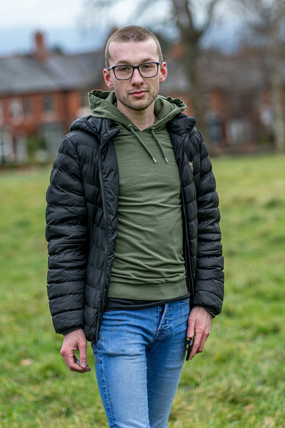 man in black zip up jacket and green shirt