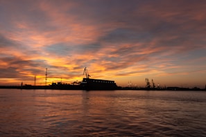 A dramatic sunset over an industrial area reflecting themes of change and decay.