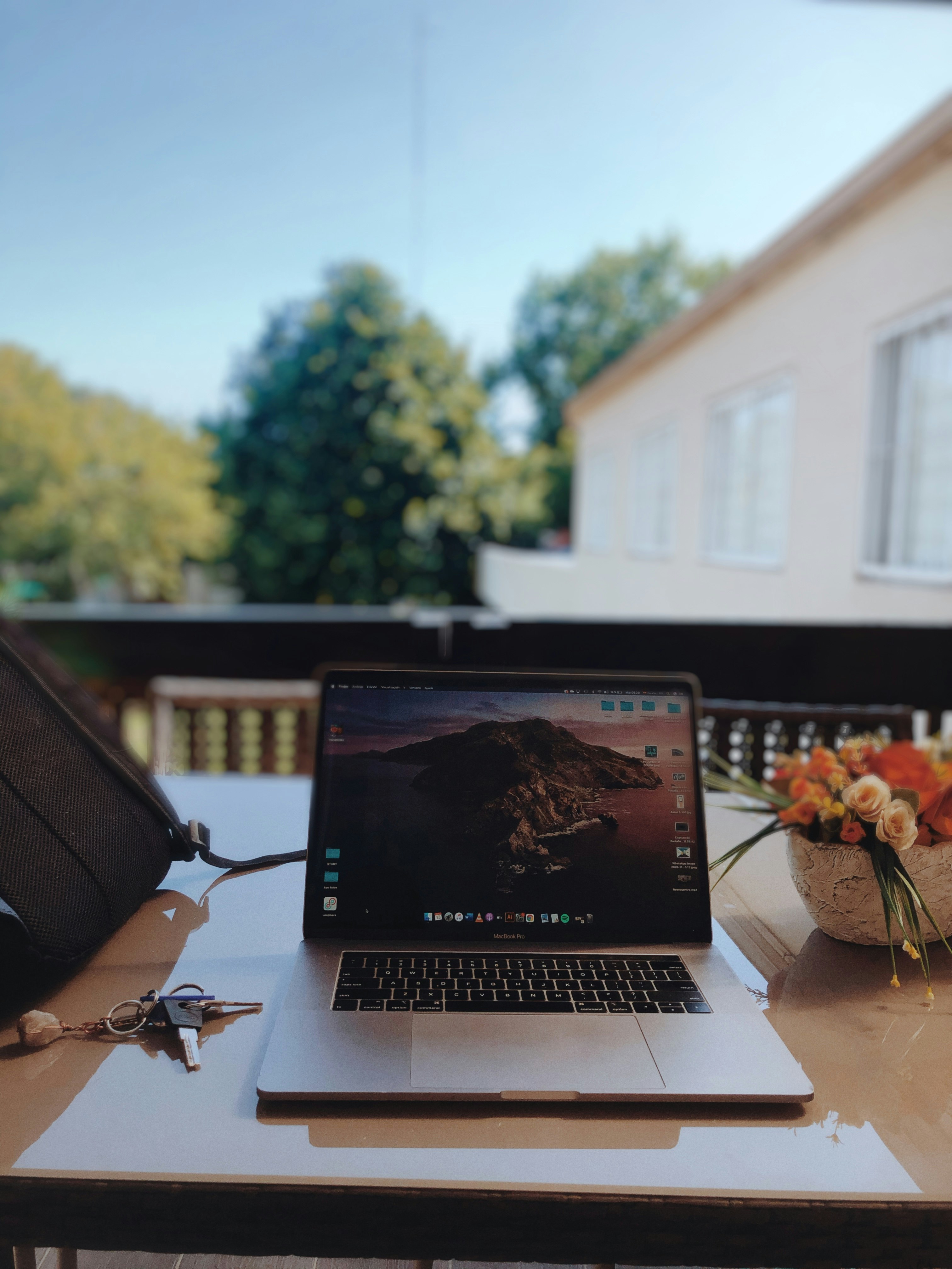macbook pro on brown wooden table