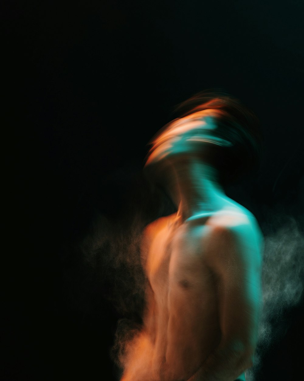 topless woman with blue and green smoke