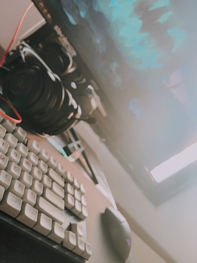 An assortment of computer accessories including keyboards, mice, and headphones on a desk.