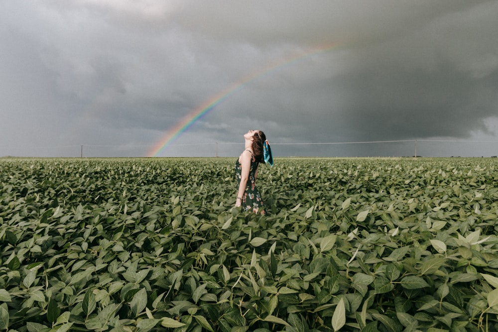 woman in black tank top and black shorts standing on green grass field