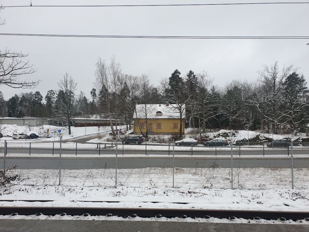 yellow and white concrete building near trees during daytime