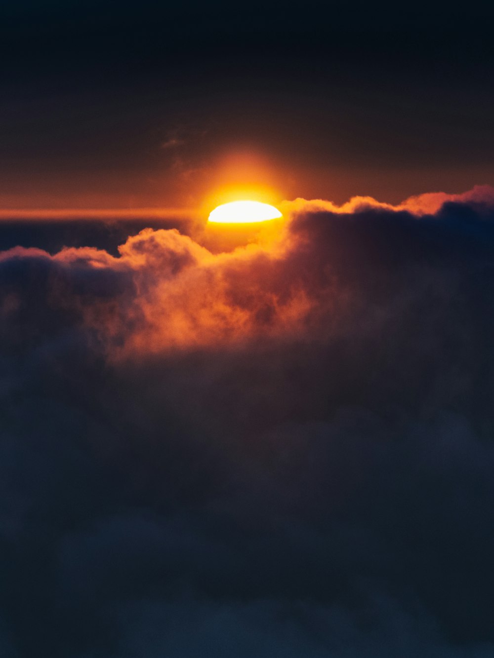 sun setting over the clouds