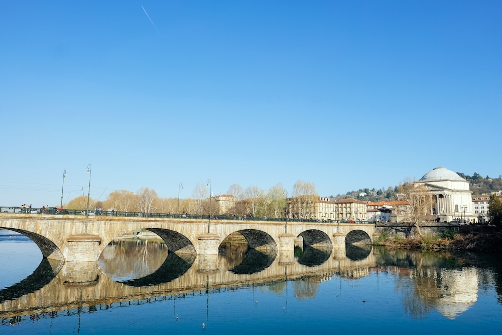 brown concrete bridge over river during daytime