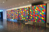 Gallery view showcasing multiple painted panels with vibrant colors.