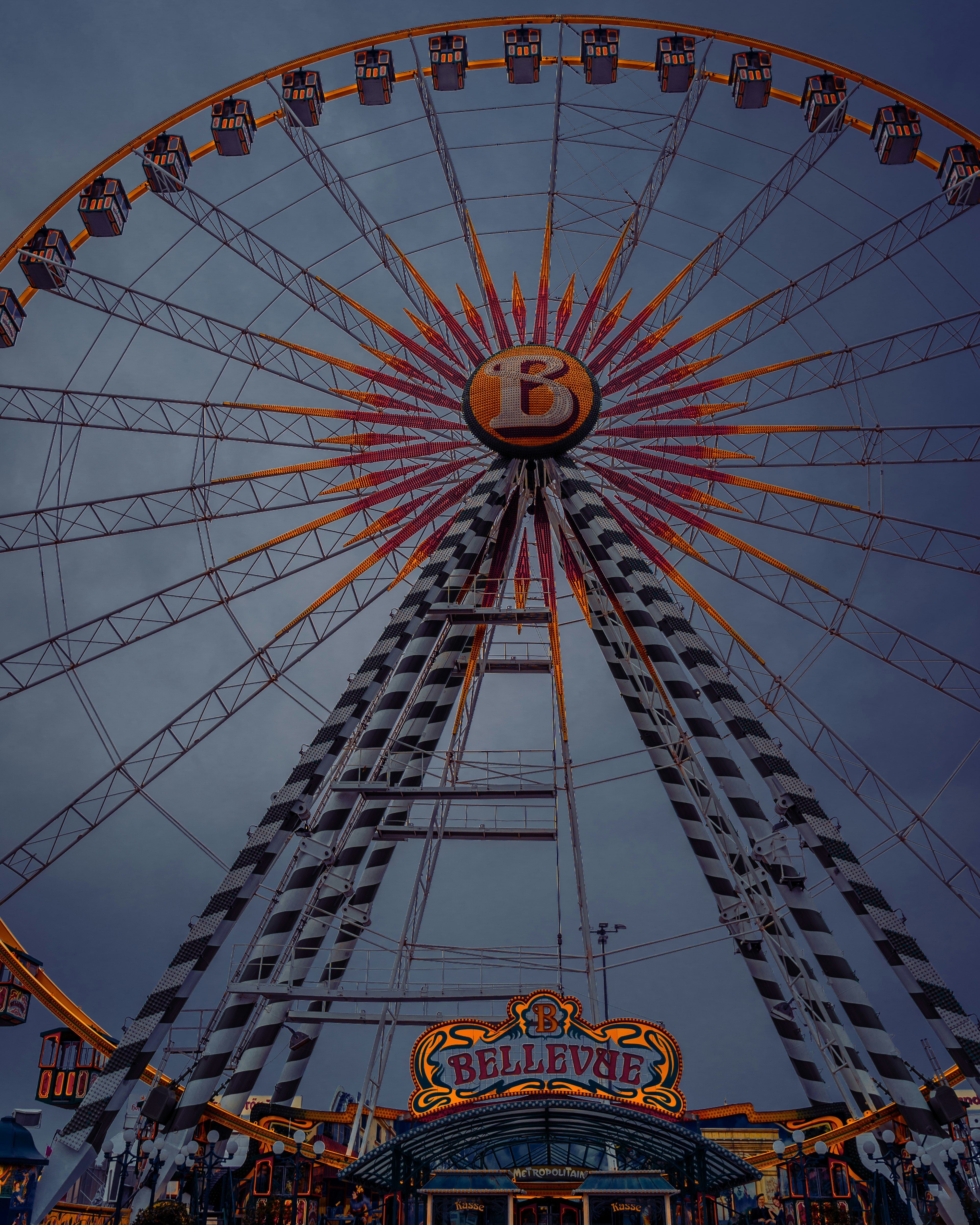 low angle photography of blue and yellow ferris wheel
