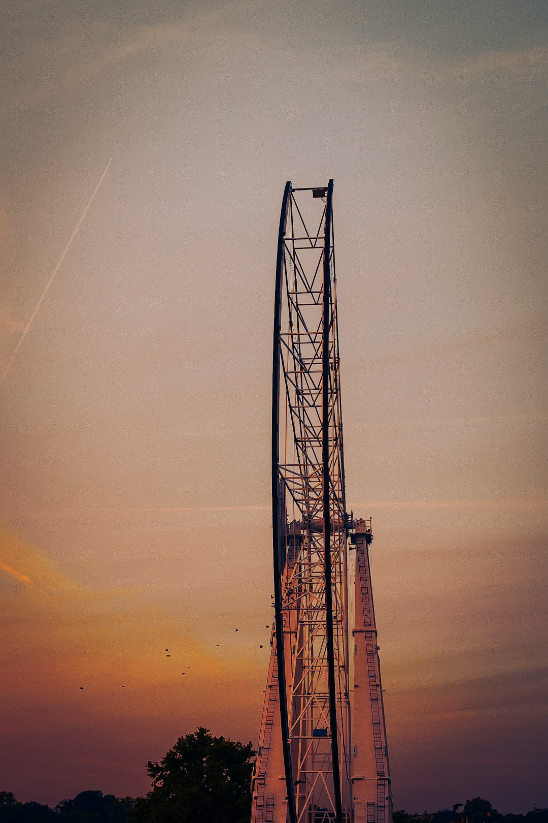 red metal tower during sunset