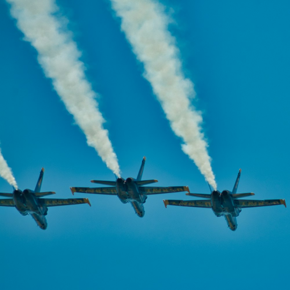 black jet plane in mid air during daytime